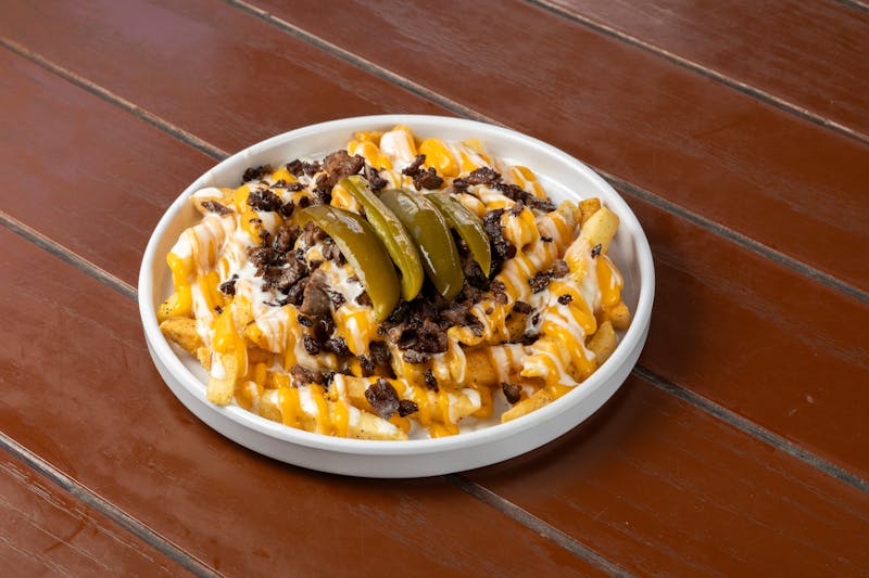 Loaded fries with cheese sauce and jalapeños